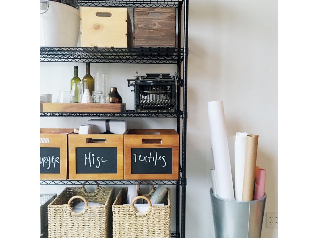 Organized items on a black wire shelving unit with labeled baskets.